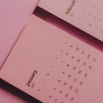 modern monthly calendar on table on pink background