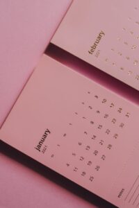 modern monthly calendar on table on pink background